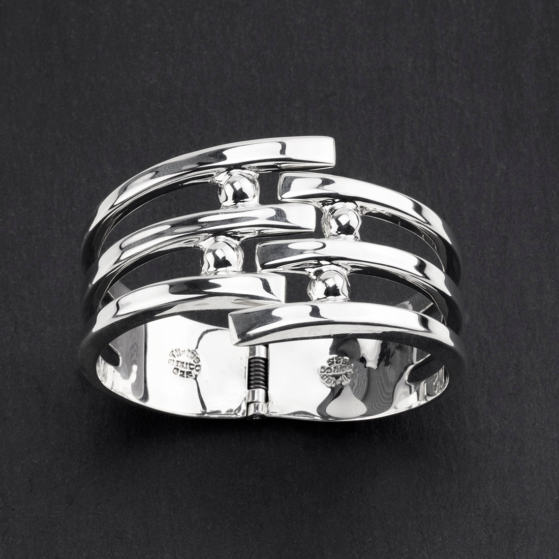 Taxco orbit sterling silver hinged bracelet